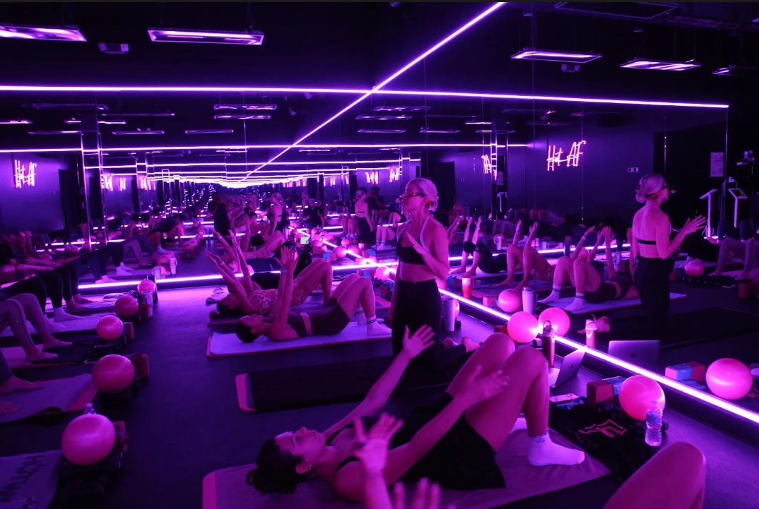 Hot Mat Pilates instructor teaching a full class at FIT AS FIRE